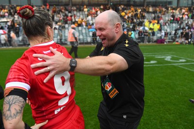 260725 - Australia Women v Wales Women - Sean Lynn, Wales Women head coach celebrates with Keira Bevan of Wales at the end of the match