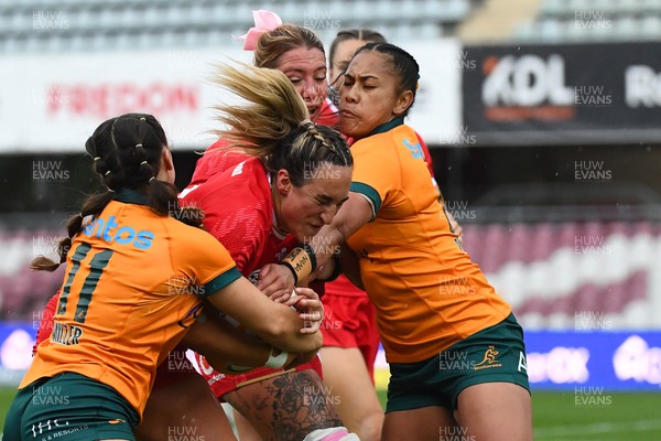 260725 - Australia Women v Wales Women - Courtney Keight of Wales is tackled