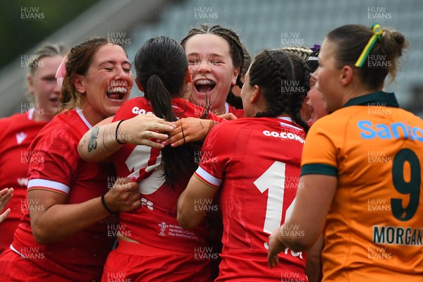 260725 - Australia Women v Wales Women - Nel Metcalfe of Wales is congratulated by Georgia Evans of Wales and Maisie Davies of Wales after she powers over to score try