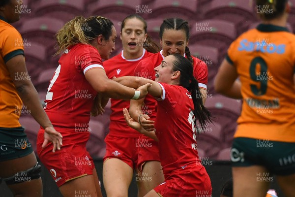 260725 - Australia Women v Wales Women - Nel Metcalfe of Wales is congratulated by Courtney Keight of Wales after her second try