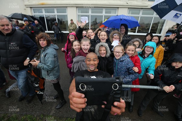 271119 - Barbarians Rugby Training Session, Penarth RFC - Cornal Hendricks of the Barbarians poses for photographs with local schoolchildren after the Barbarians training session at Penarth RFC ahead of their match against Wales