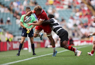270626 - Barbarians v Wales - Friendly - Taine Plumtree of Wales is tackled by Virimi Vakatawa of Barbarians 