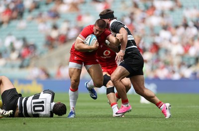 270626 - Barbarians v Wales - Friendly - Joe Hawkins of Wales is tackled by Nathan Hughes of Barbarians 