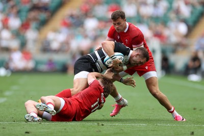 270626 - Barbarians v Wales - Friendly - George North of Barbarians is tackled by Ellis Mee and Mason Grady of Wales 