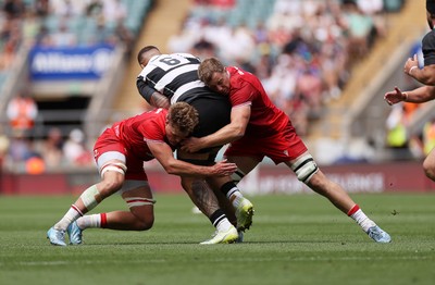 270626 - Barbarians v Wales - Friendly - Taine Plumtree and Ben Carter of Wales tackle Lukhan Salakaia-Loto of Barbarians 