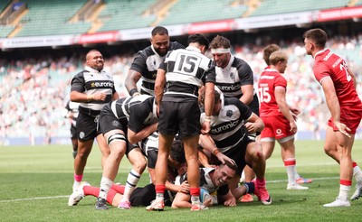 270626 - Barbarians v Wales - George North of Barbarians is mobbed by team mates after he races in to score try