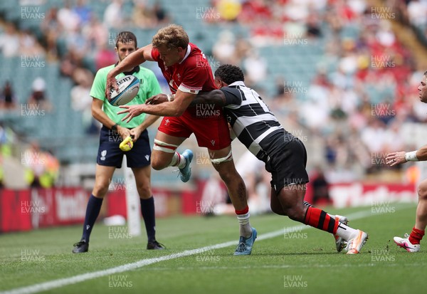 270626 - Barbarians v Wales - Friendly - Taine Plumtree of Wales is tackled by Virimi Vakatawa of Barbarians 