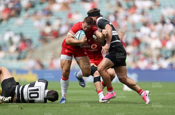 270626 - Barbarians v Wales - Friendly - Joe Hawkins of Wales is tackled by Nathan Hughes of Barbarians 