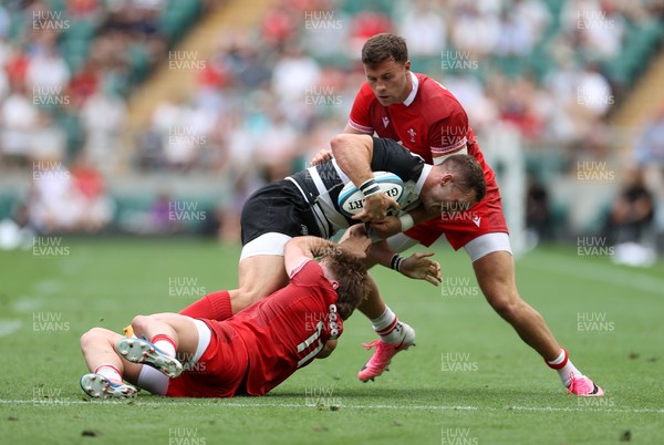 270626 - Barbarians v Wales - Friendly - George North of Barbarians is tackled by Ellis Mee and Mason Grady of Wales 