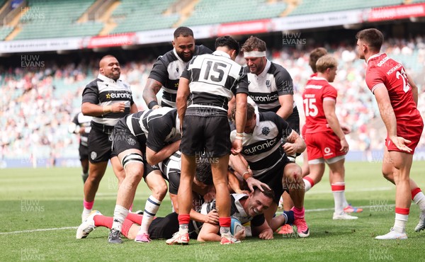 270626 - Barbarians v Wales - George North of Barbarians is mobbed by team mates after he races in to score try