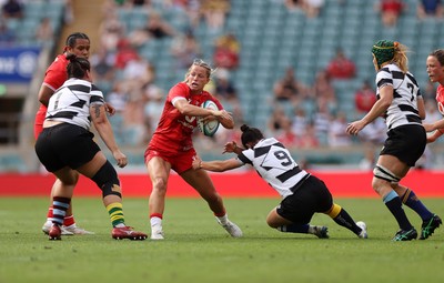 270626 - Barbarians Women v Wales Women - Friendly - Amy Williams of Wales is tackled by Caity Mattinson of Barbarians 