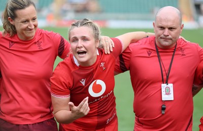 270626 - Barbarians v Wales Women -Alex Callender of Wales and Sean Lynn, Wales Women head coach speak to the players  at the end of the match