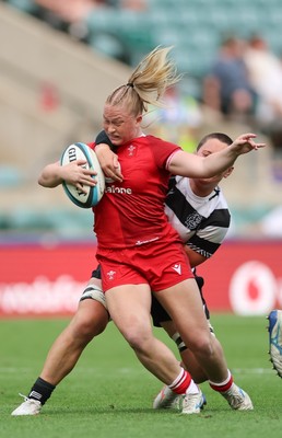 270626 - Barbarians v Wales Women - Seren Lockwood of Wales is tackled by Poppy Leitch of Barbarians