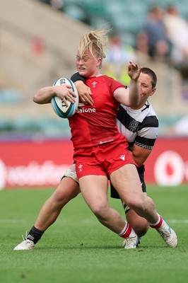 270626 - Barbarians v Wales Women - Seren Lockwood of Wales is tackled by Poppy Leitch of Barbarians