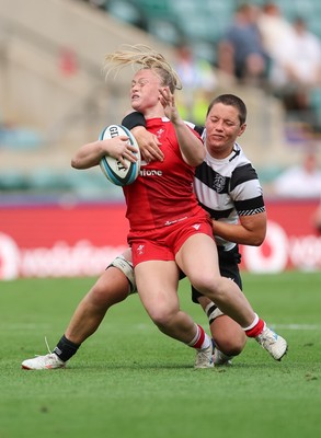 270626 - Barbarians v Wales Women - Seren Lockwood of Wales is tackled by Poppy Leitch of Barbarians