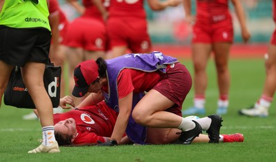 270626 - Barbarians v Wales Women - Nel Metcalfe of Wales receives treatment after picking up an injury