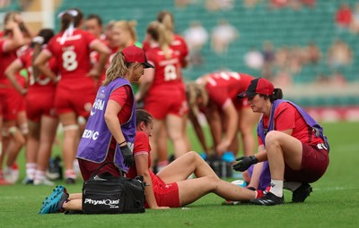 270626 - Barbarians v Wales Women - Nel Metcalfe of Wales receives treatment after picking up an injury