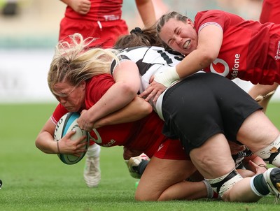 270626 - Barbarians v Wales Women - Kelsey Jones of Wales is tackled just short of the line