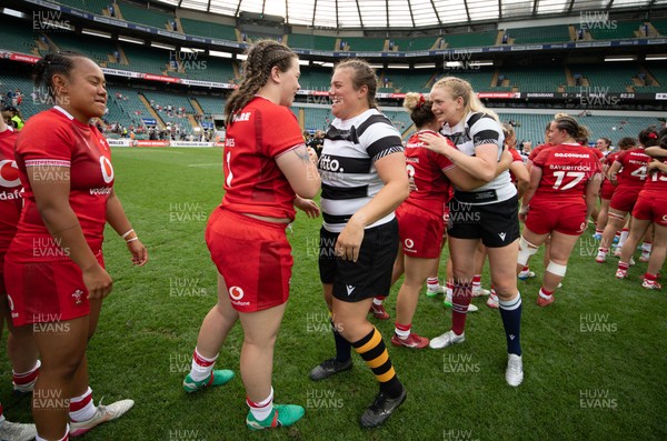 270626 - Barbarians v Wales Women - Maisie Davies of Wales with Welsh team mate Carys Phillips of Barbarians at the end of the match