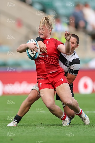 270626 - Barbarians v Wales Women - Seren Lockwood of Wales is tackled by Poppy Leitch of Barbarians