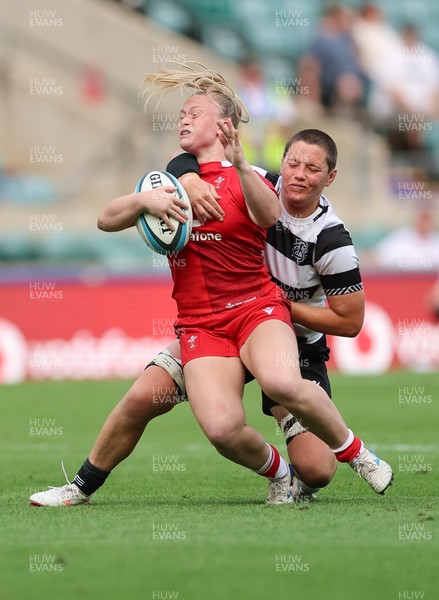 270626 - Barbarians v Wales Women - Seren Lockwood of Wales is tackled by Poppy Leitch of Barbarians
