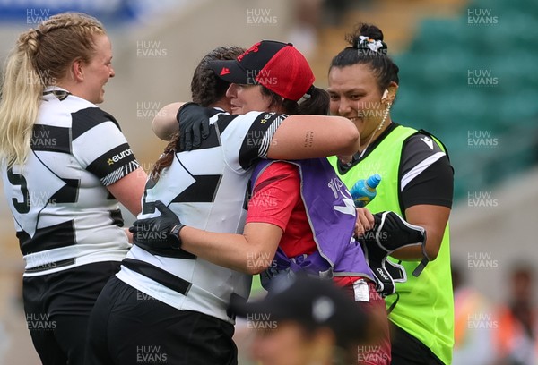 270626 - Barbarians v Wales Women - Carys Phillips of Barbarians is embraced by Dr Gwennan Williams, Wales team doctor