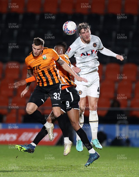 121223 - Barnet FC v Newport County - FA Cup Second Round Replay - Ryan Delaney of Newport County goes up for the ball with Jordan Cropper and Nicke Kabamba of Barnet 