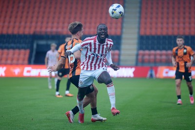 290725 - Barnet v Newport County - Carabao Cup Preliminary Round - Cameron Antwi of Newport County is tackled by Ryan Glover of Barnet