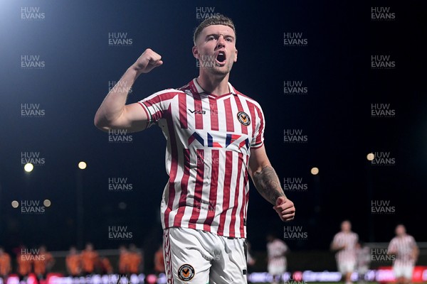 290725 - Barnet v Newport County - Carabao Cup Preliminary Round - Cameron Evans of Newport County scores the winning penalty and runs to celebrate with the fans