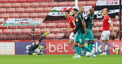 191019 - Barnsley v Swansea City - Sky Bet Championship - Freddie Woodman of Swansea saves from a disappointed Cauley Woodrow of Barnsley