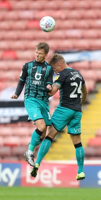 191019 - Barnsley v Swansea City - Sky Bet Championship - Jake Bidwell of Swansea and Tom Carroll of Swansea both go up for the same header