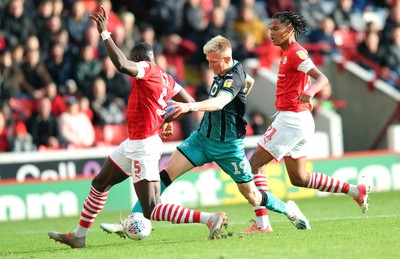 191019 - Barnsley v Swansea City - Sky Bet Championship - Sam Surridge of Swansea tries to go through Bambo Diaby of Barnsley and Toby Sibbick of Barnsley