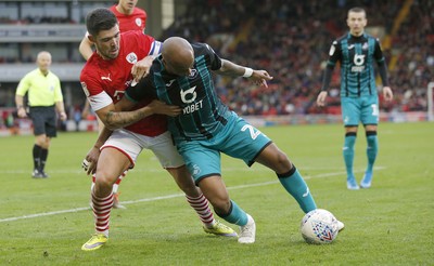 191019 - Barnsley v Swansea City - Sky Bet Championship - Andre Ayew of Swansea and Alex Mowatt of Barnsley