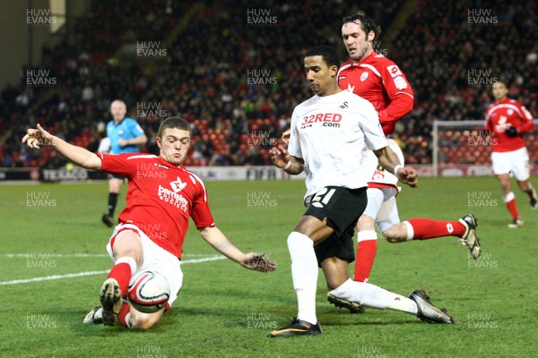 22.01.11 -Barnsley v Swansea City, Npower Championship - Swansea City's Scott Sinclair is tackled by Barnsley's Kieran Trippier 