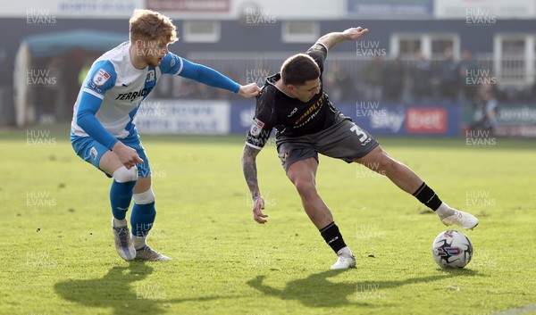 230324 - Barrow v Newport County - Sky Bet League 2 - Adam Lewis of Newport County is caught by the shirt by Luca Stephenson of Barrow