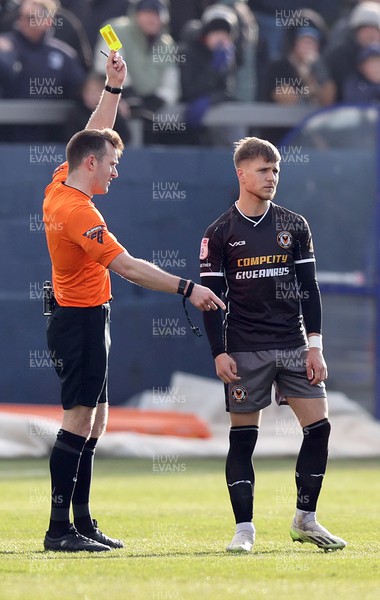230324 - Barrow v Newport County - Sky Bet League 2 - Lewis Payne of Newport County is booked for a foul on Kian Spence of Barrow