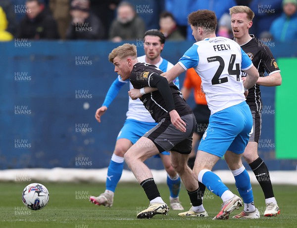 230324 - Barrow v Newport County - Sky Bet League 2 - Will Evans of Newport Countyis tackled by Rory Feely of Barrow