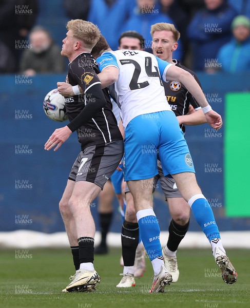 230324 - Barrow v Newport County - Sky Bet League 2 - Will Evans of Newport Countyis tackled by Rory Feely of Barrow
