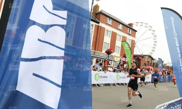 040819 - Barry Island 10k road race, Barry - Runners head to the finish in the Barry Island 10K