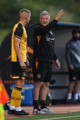 250725 - Barry Town United v Newport County - Pre Season Friendly - Newport County Assistant Manager, Wayne Hatswell leads the dugout