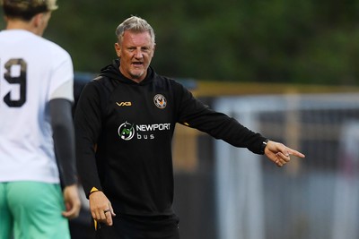 250725 - Barry Town United v Newport County - Pre Season Friendly - Newport County Assistant Manager, Wayne Hatswell leads the dugout