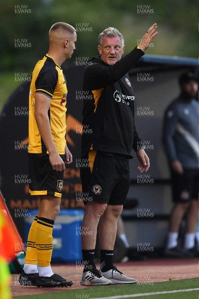 250725 - Barry Town United v Newport County - Pre Season Friendly - Newport County Assistant Manager, Wayne Hatswell leads the dugout