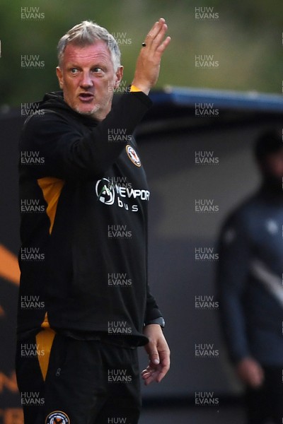 250725 - Barry Town United v Newport County - Pre Season Friendly - Newport County Assistant Manager, Wayne Hatswell leads the dugout
