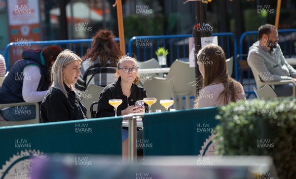 260421 Bars and restaurants reopen, Wales - People at a restaurant in Cardiff after a lifting of Welsh Government COVID-19 restrictions today allowing the establishments to serve food and drink outdoors