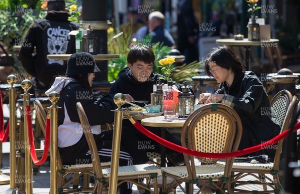 260421 Bars and restaurants reopen, Wales - People at a restaurant in Cardiff after a lifting of Welsh Government COVID-19 restrictions today allowing the establishments to serve food and drink outdoors
