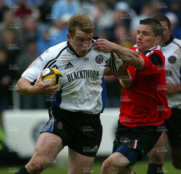 260403 - Bath v Saracens - Parker Pen Challenge Cup Semi Final Second Leg - Bath Centre Mike Tindall hands off Saracens Centre Kevin Sorrell