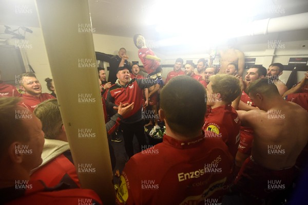 120118 - Bath v Scarlets - European Rugby Champions Cup - Wayne Pivac lifts the rag doll as the Scarlets players celebrate in the dressing room