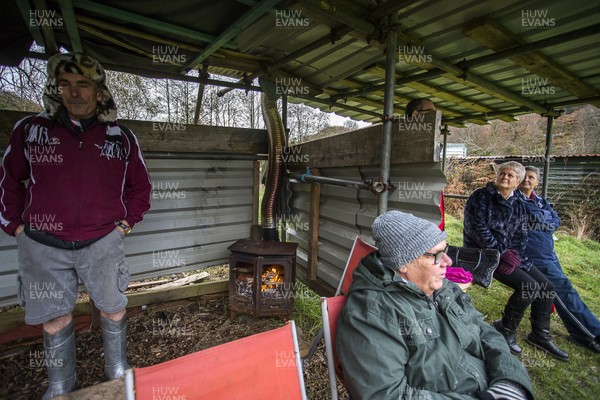 161119 - Bedlinog RFC v Senghenydd RFC - WRU Specsavers Plate - Picture shows a group of spectators watching the game with two wood burning fires in their shelter