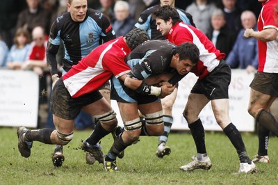 27.03.10 Bedwas RFC v Cardiff RFC - Swalec Cup 1/4 final - Cardiff's Ashley Sweet drives on as Bedwas' Robert Carter(L) & Jamie Jones make the tackles. 