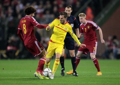 161114 - Belgium v Wales - European Championship Qualifier - Aaron Ramsey of Wales is tackled by Marouane Fellaini of Belgium 